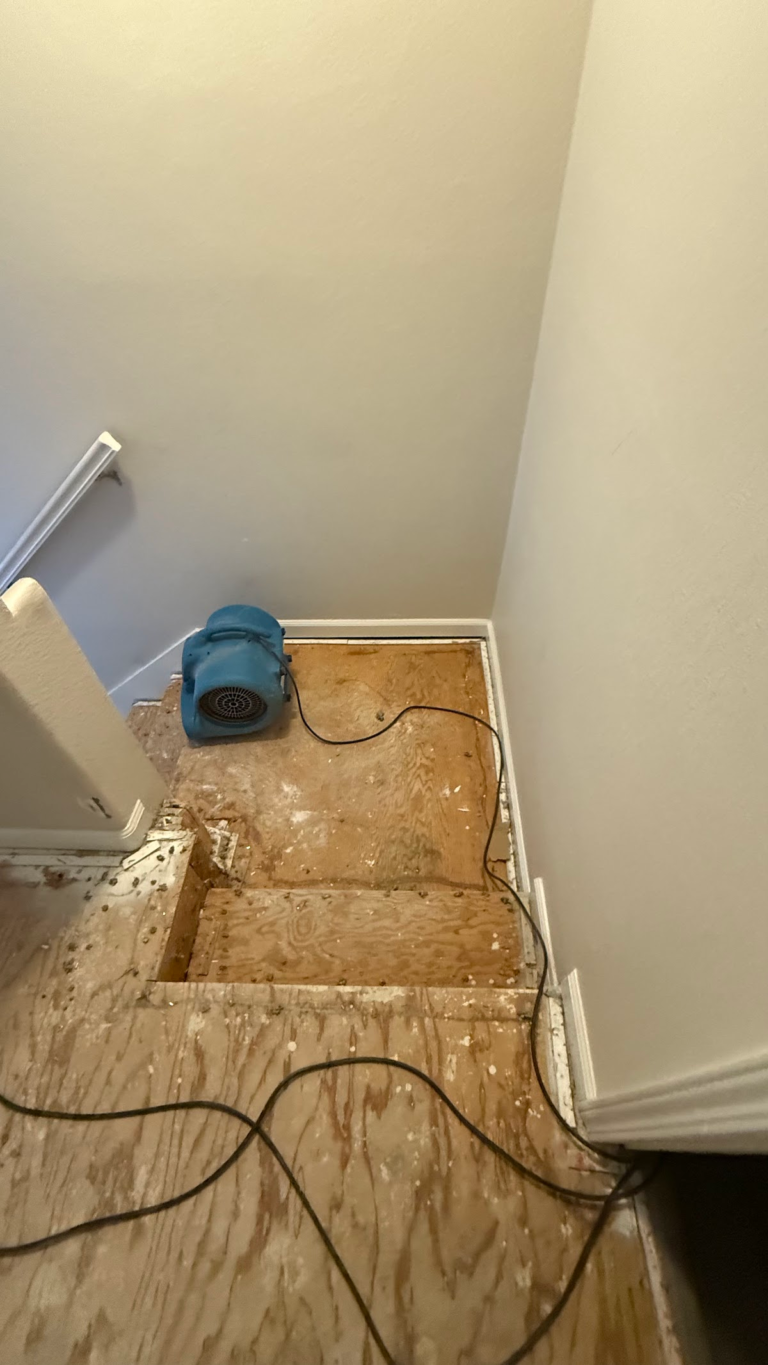 Air mover drying stair landing during the Las Vegas home restoration project.