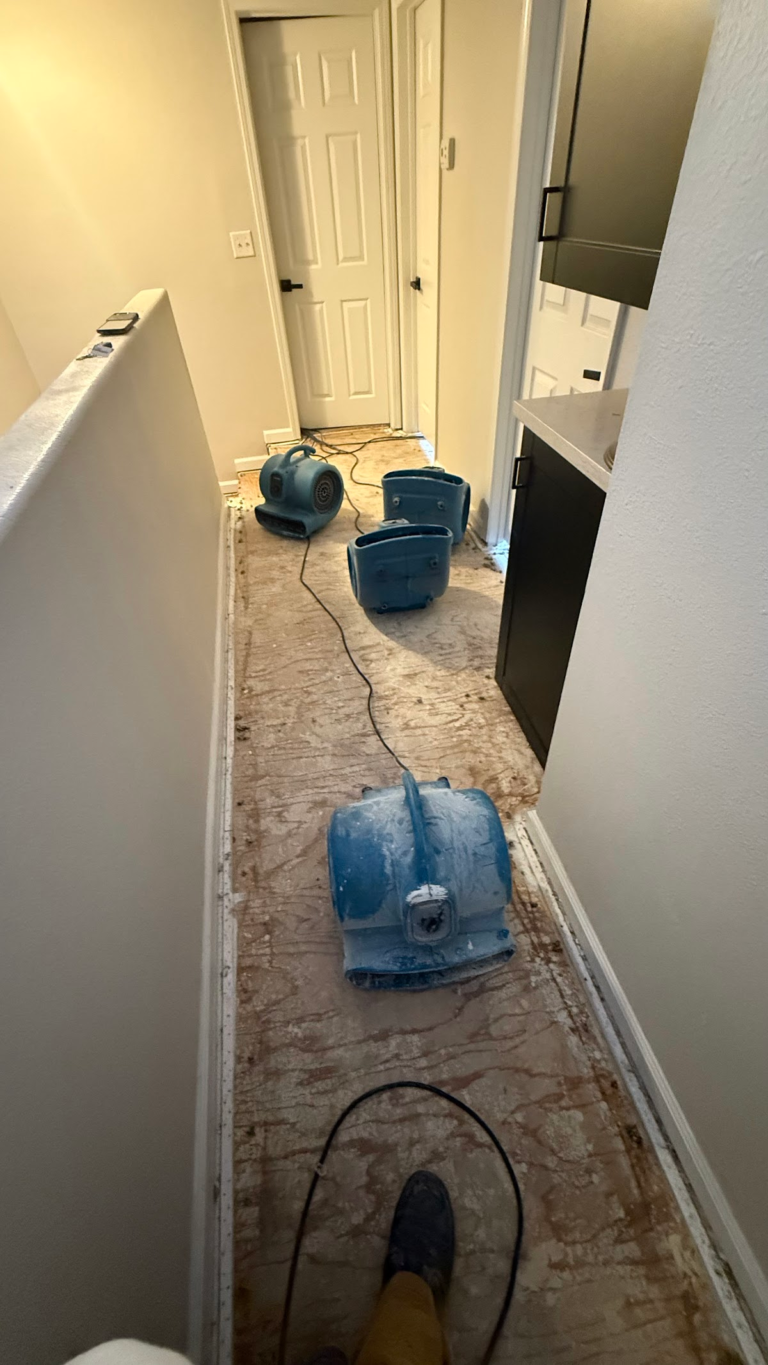 Air movers along stripped hallway during the Las Vegas home restoration project.