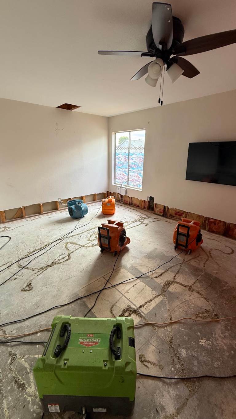 Air movers drying exposed subfloor during the Las Vegas home restoration project.