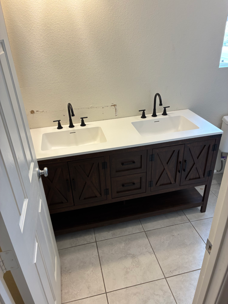 Completed double bathroom vanity installation with two sinks and black faucets in Las Vegas