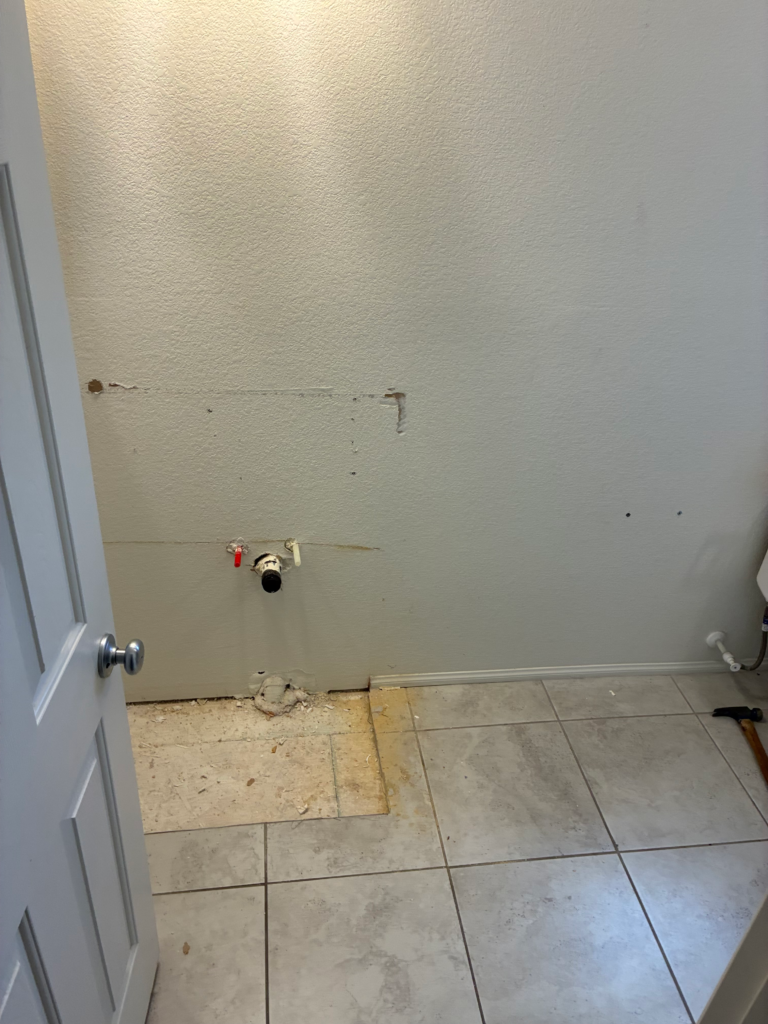 Bathroom vanity removed with plumbing exposed before a single-to-double conversion in Las Vegas