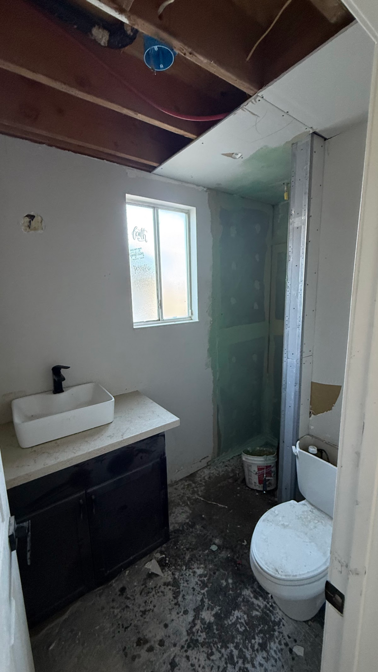 Bathroom ceiling opened to framing during the Las Vegas home restoration project.