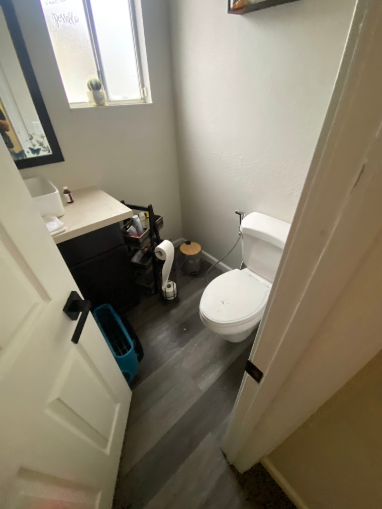 Bathroom vanity and toilet before restoration during the Las Vegas home restoration project.