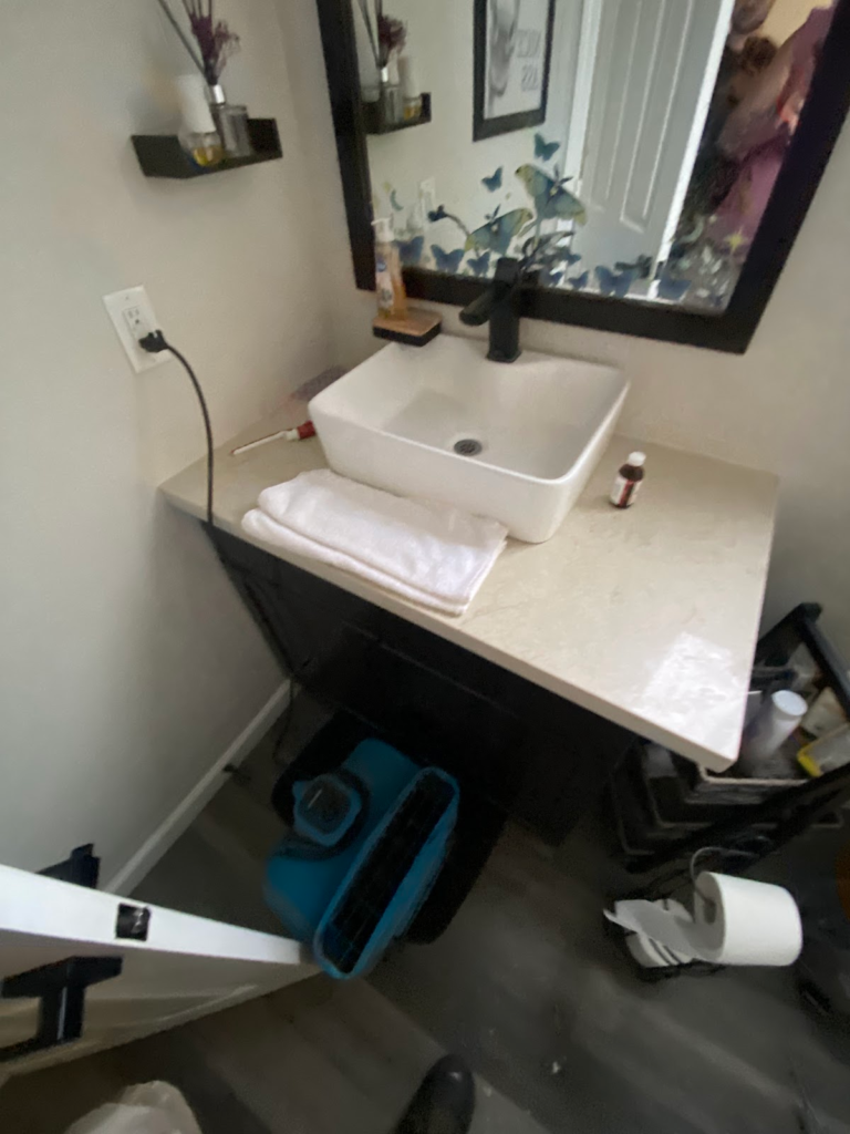 Bathroom vanity with drying fan during the Las Vegas home restoration project.