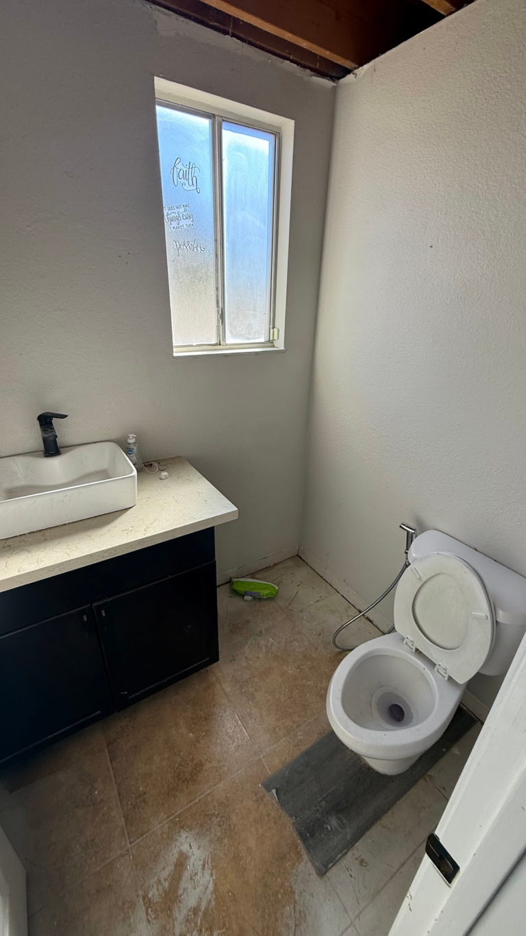 Bathroom with exposed ceiling and floor during the Las Vegas home restoration project.