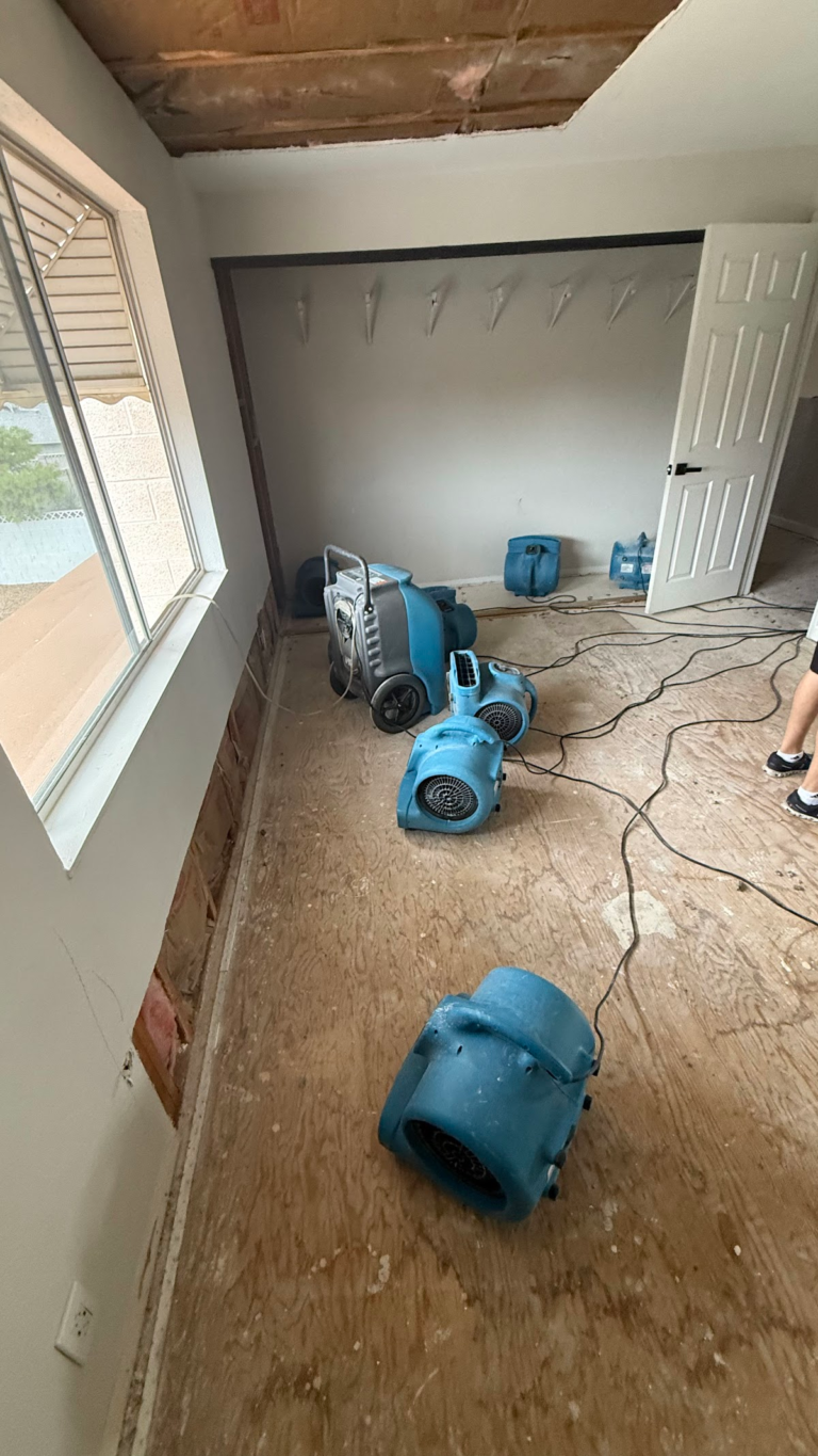 Bedroom air movers on exposed subfloor during the Las Vegas home restoration project.