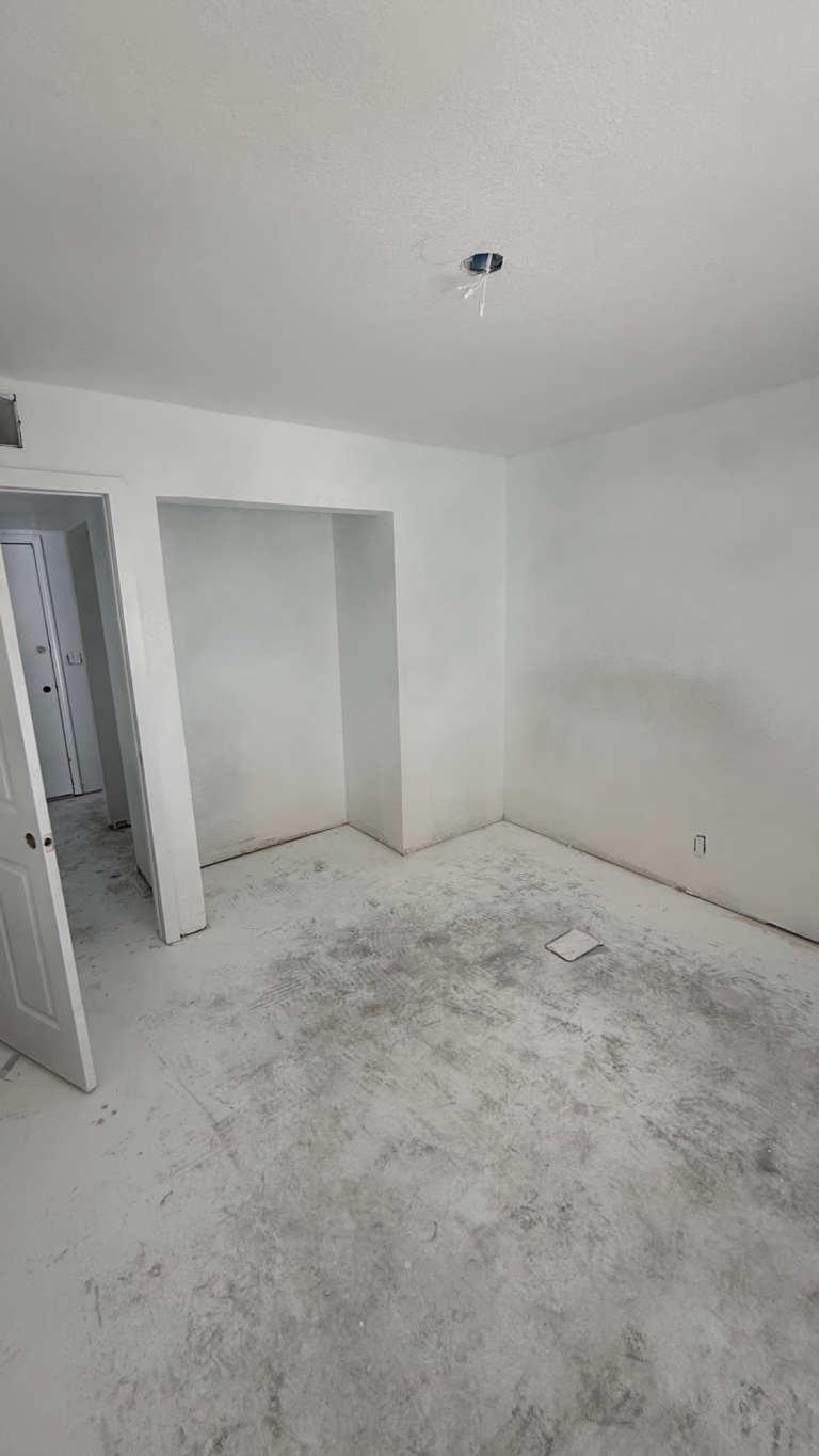 Bedroom closet after wall finishing during the Las Vegas home restoration project.