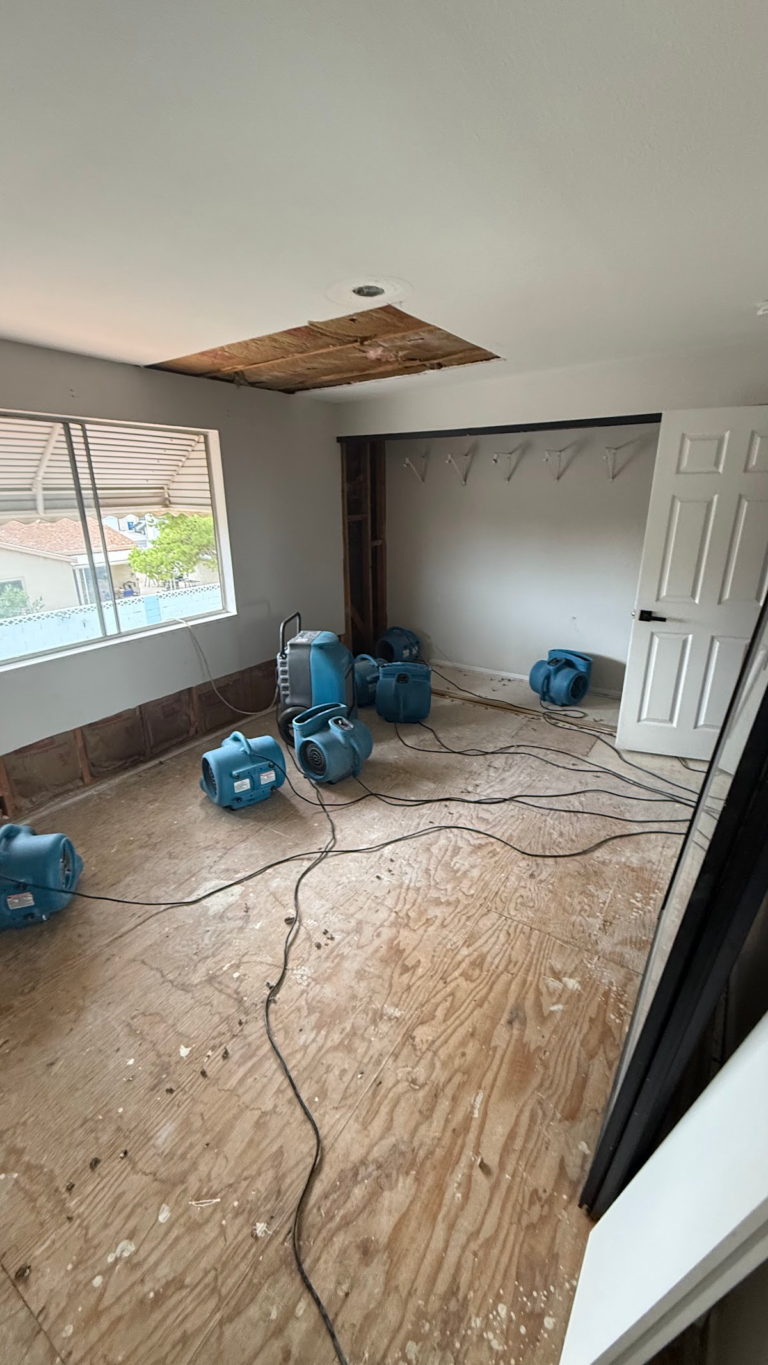 Bedroom drying equipment beside window during the Las Vegas home restoration project.