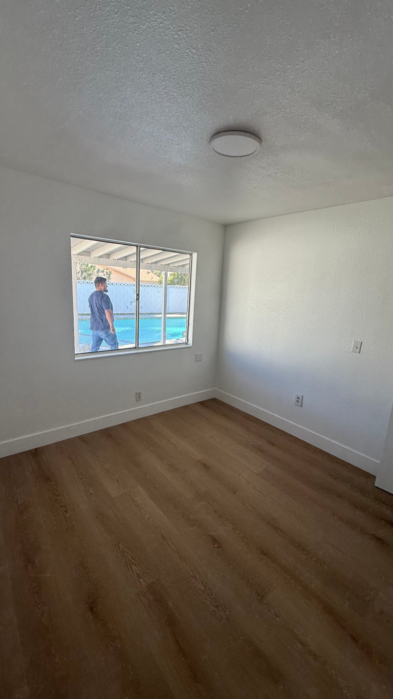 Bedroom window and white wall finish during the Las Vegas home restoration project.