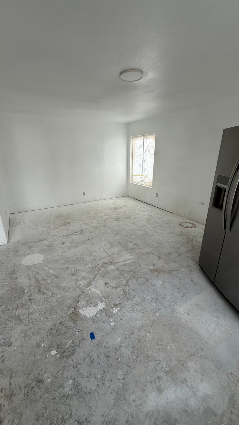 Bedroom with painted walls and bare floor during the Las Vegas home restoration project.