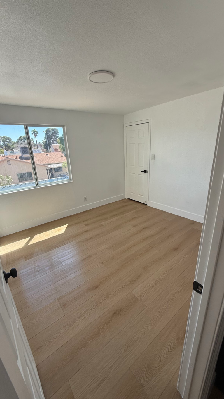 Bright bedroom with finished flooring during the Las Vegas home restoration project.