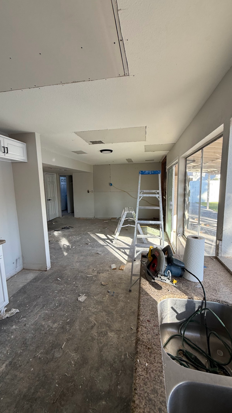 Ceiling drywall repair above open living area during the Las Vegas home restoration project.