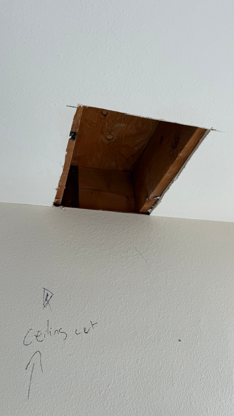 Ceiling opening exposing wood structure during the Las Vegas home restoration project.