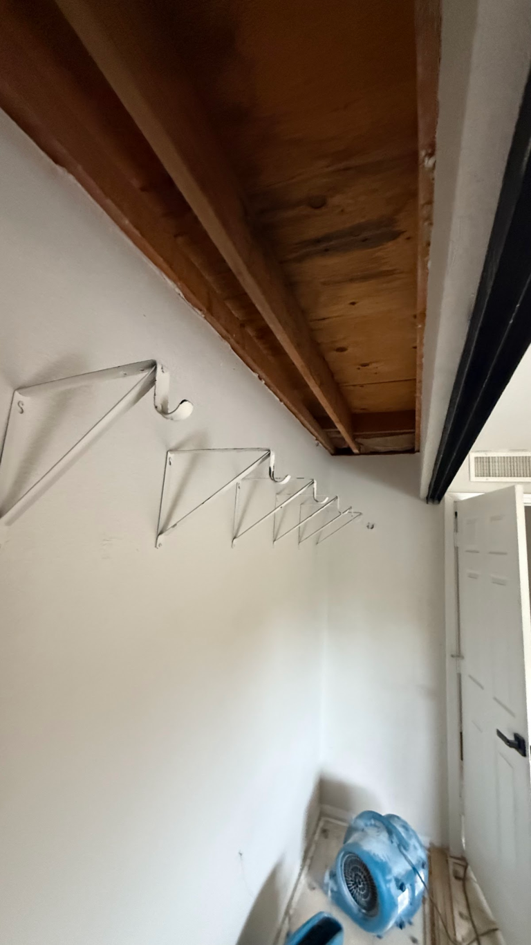 Closet ceiling opened to wooden joists during the Las Vegas home restoration project.