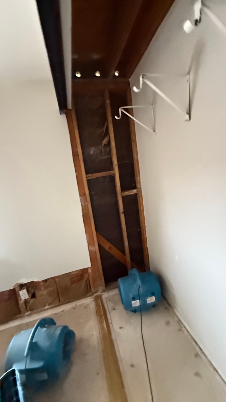 Closet wall and ceiling opened for drying during the Las Vegas home restoration project.