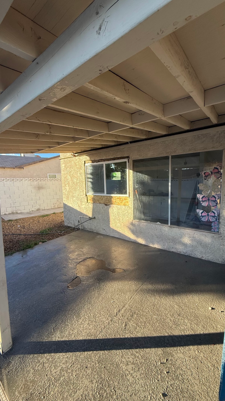 Covered patio with exposed roof framing during the Las Vegas home restoration project.
