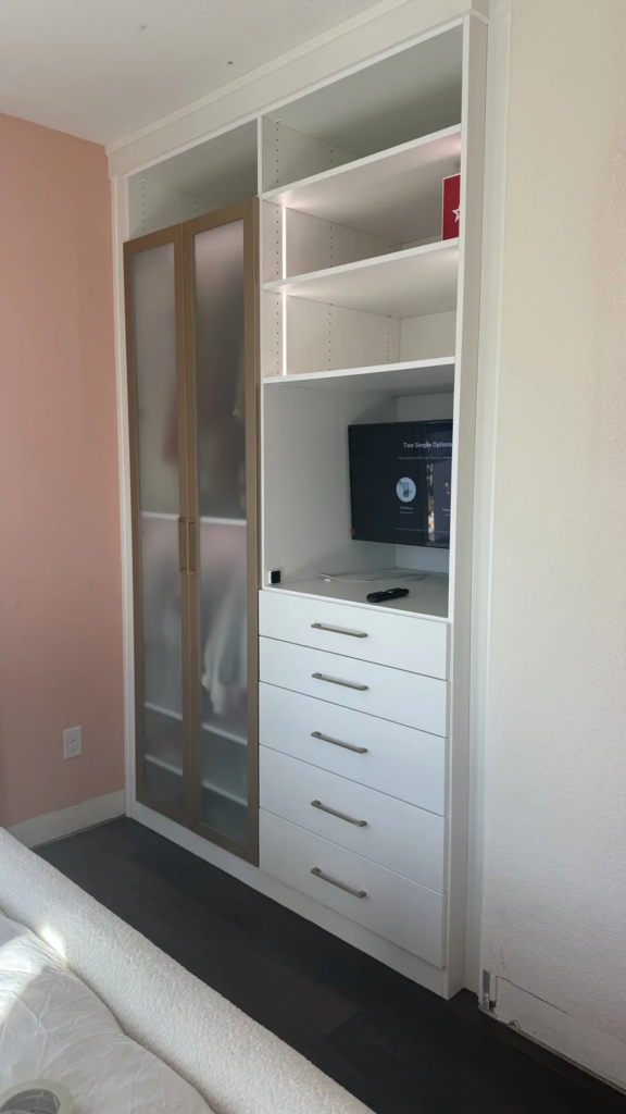 Custom bedroom built-in cabinet with frosted doors, drawers, TV niche and shelving in Las Vegas