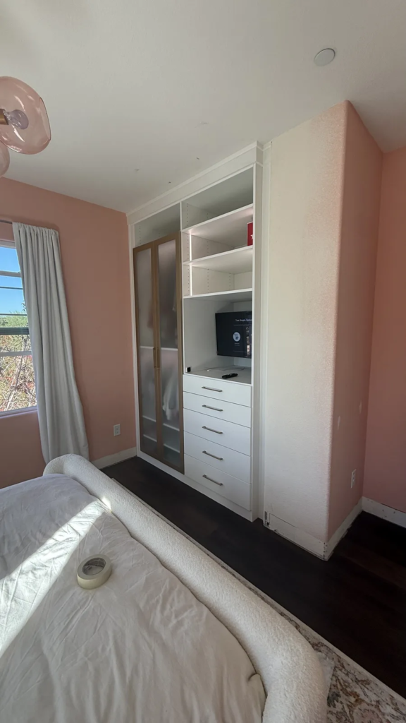 Finished custom bedroom storage cabinet with shelves, drawers and TV niche in Las Vegas