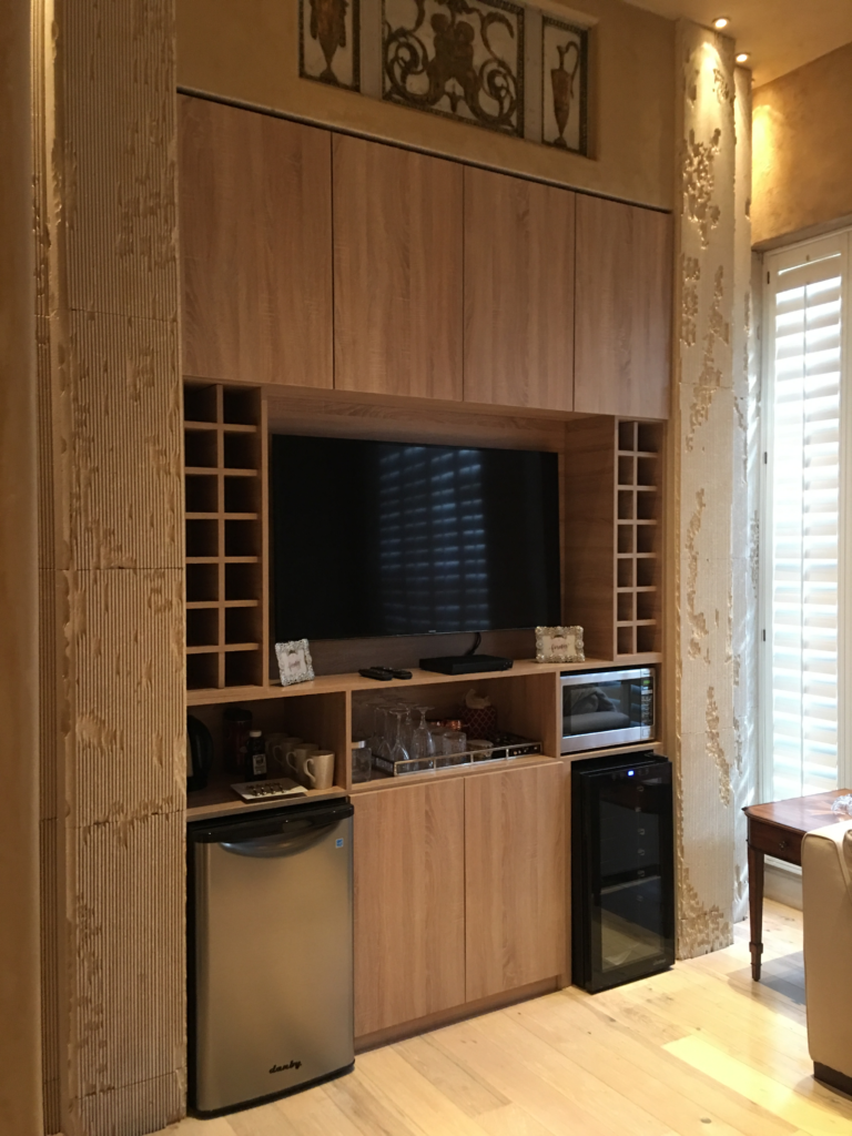 Custom carpentry built-in entertainment center with cabinetry and shelving