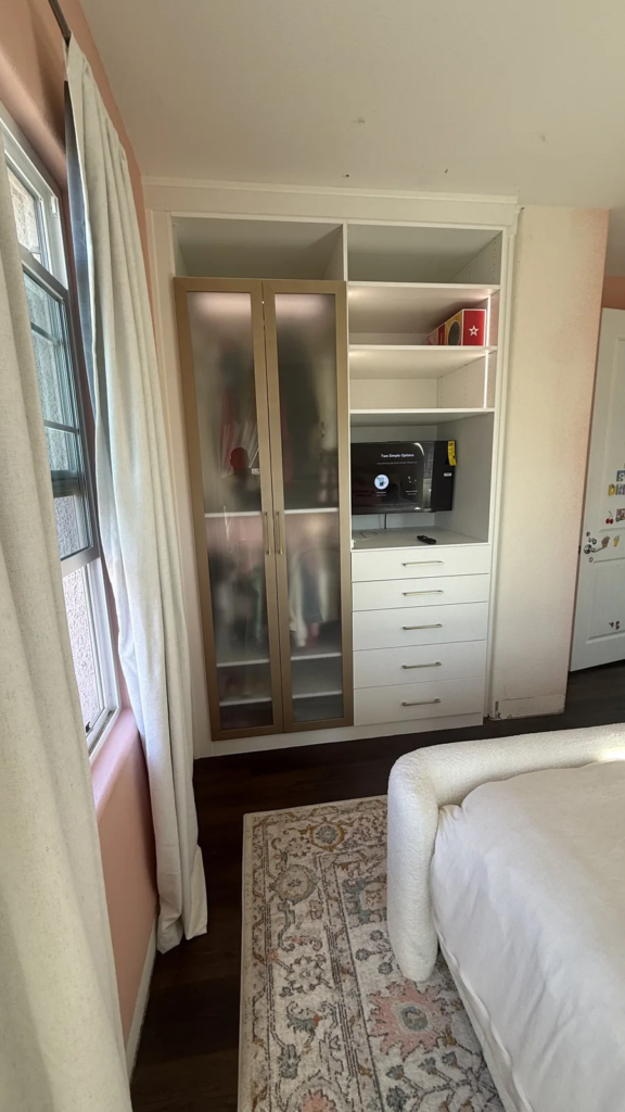 Custom built-in wardrobe with frosted glass doors, drawers, shelving and media niche in Las Vegas