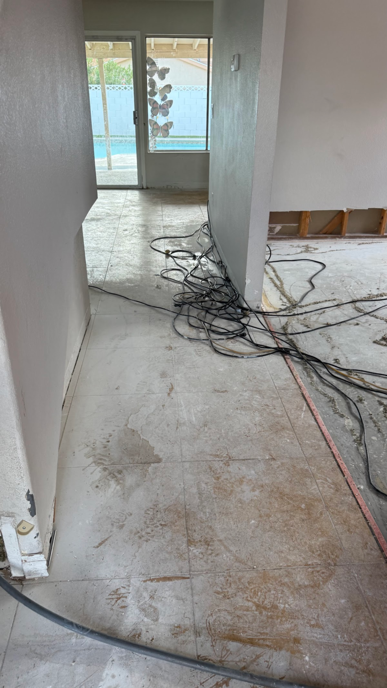 Drying equipment cables through stripped hallway during the Las Vegas home restoration project.