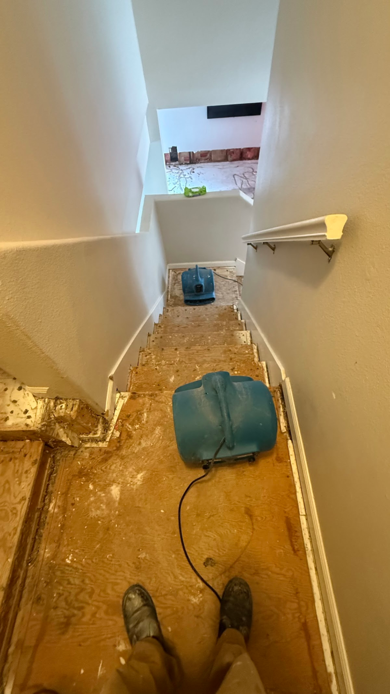 Drying equipment on exposed stair landing during the Las Vegas home restoration project.