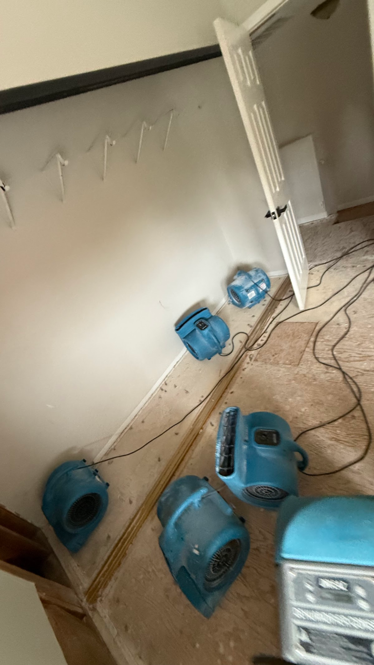 Drying fans along closet floor during the Las Vegas home restoration project.