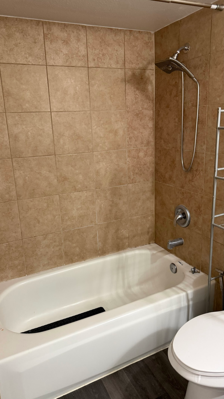 Existing bathtub and tiled surround during the Las Vegas home restoration project.
