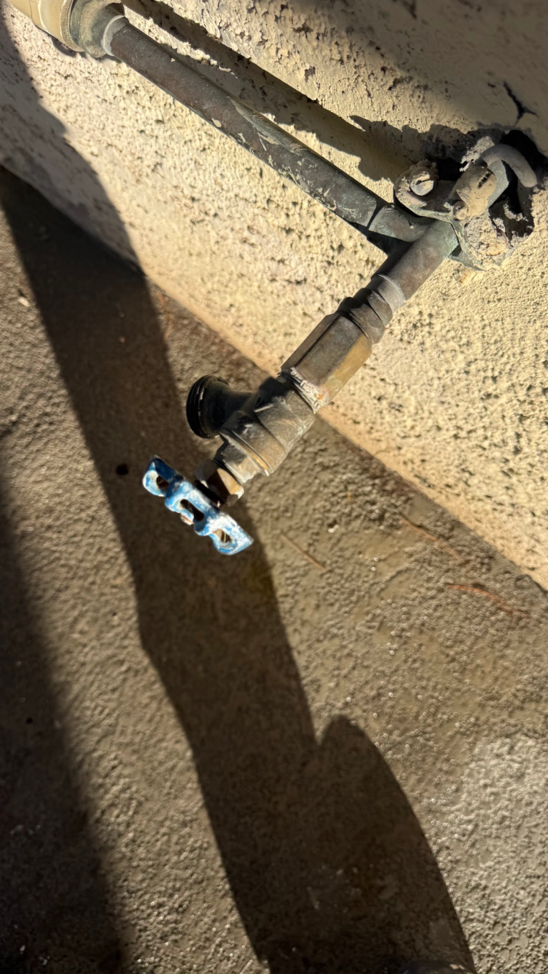 Exterior pipe and valve connection during the Las Vegas home restoration project.