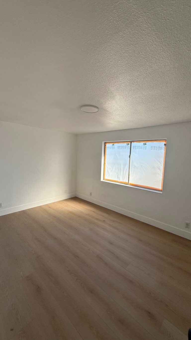 Finished bedroom window and floor during the Las Vegas home restoration project.