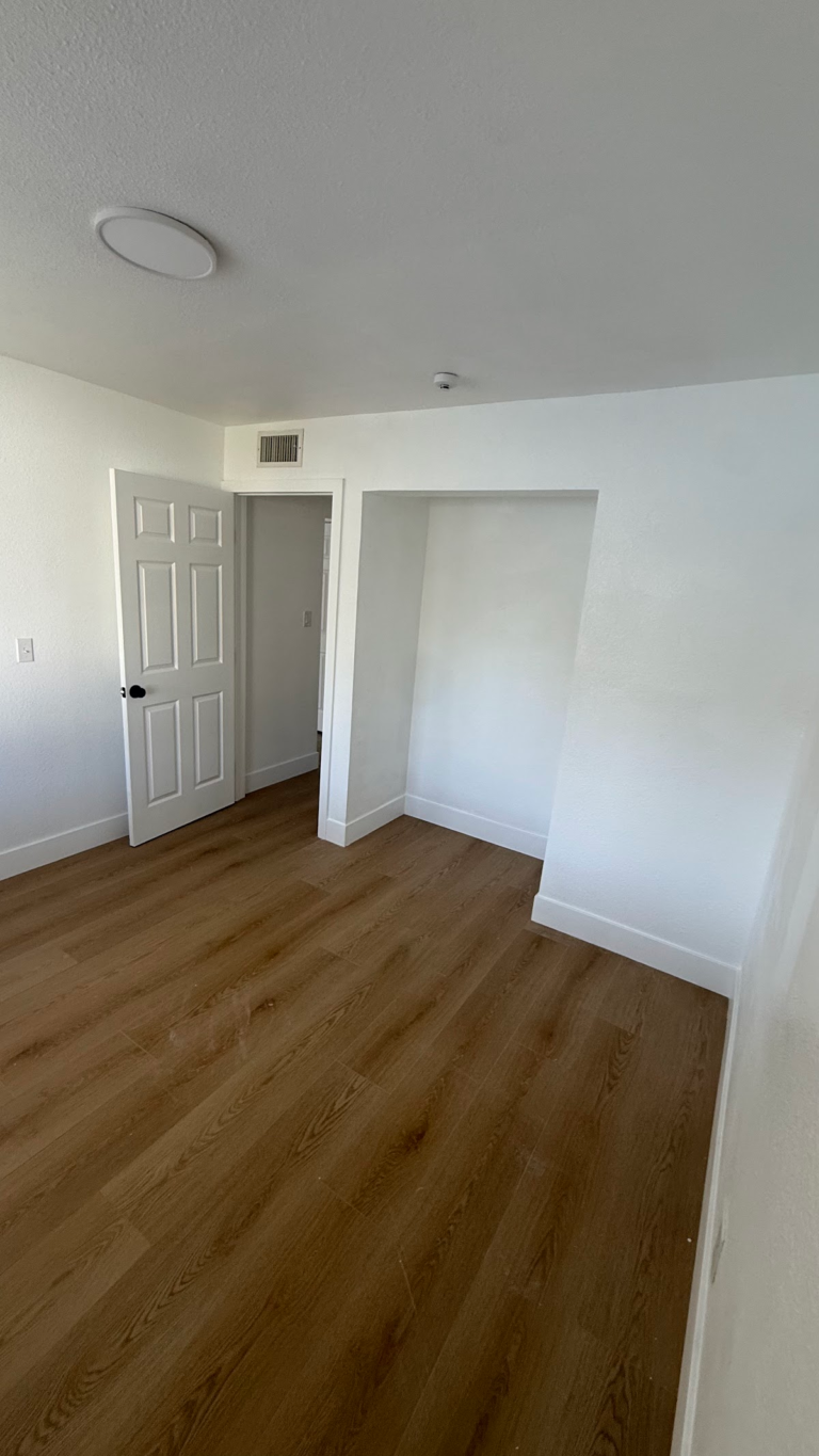 Finished bedroom with open closet during the Las Vegas home restoration project.