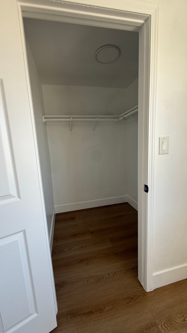 Finished closet with shelf and hanging rod during the Las Vegas home restoration project.