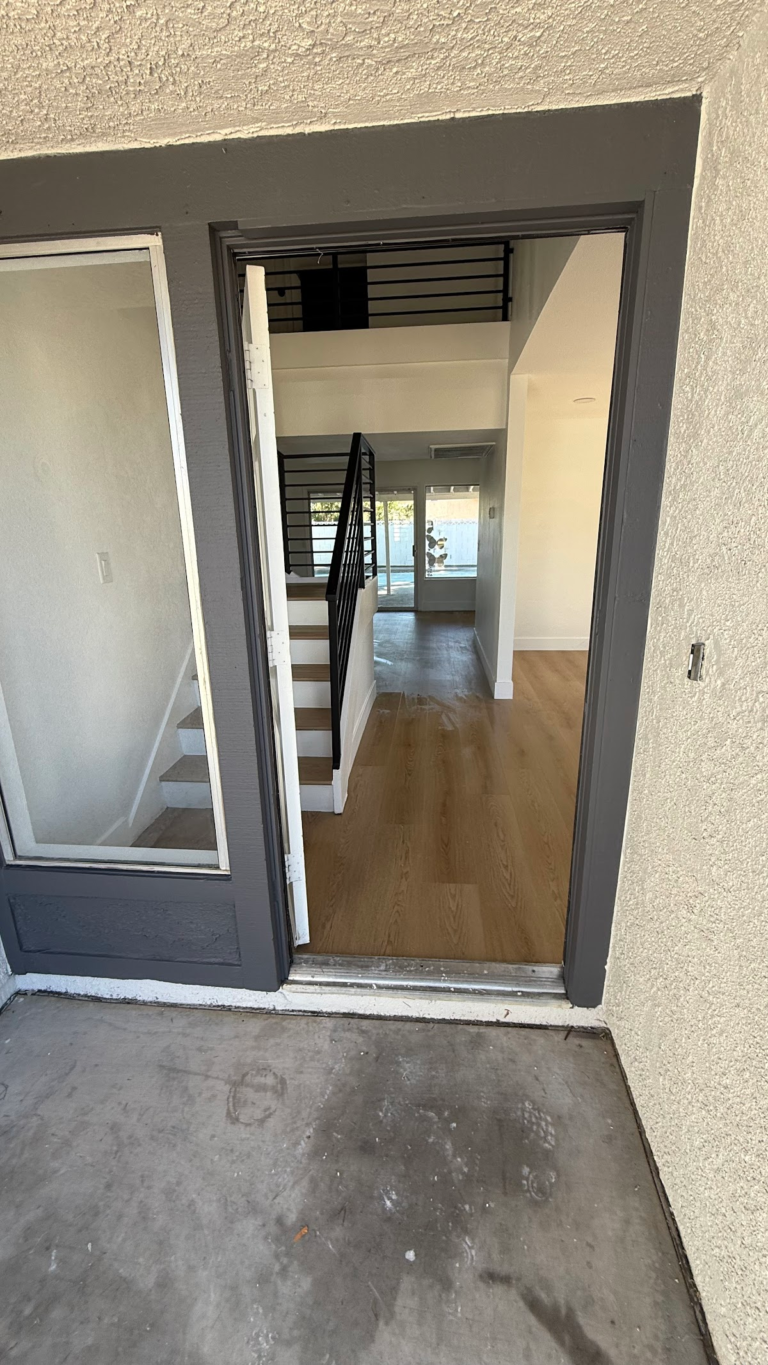 Finished entry doorway and wood-look flooring during the Las Vegas home restoration project.