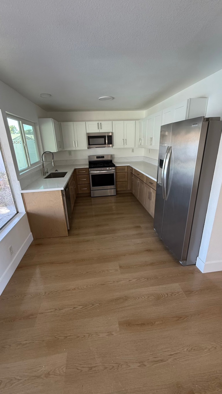 Finished kitchen with white cabinets during the Las Vegas home restoration project.