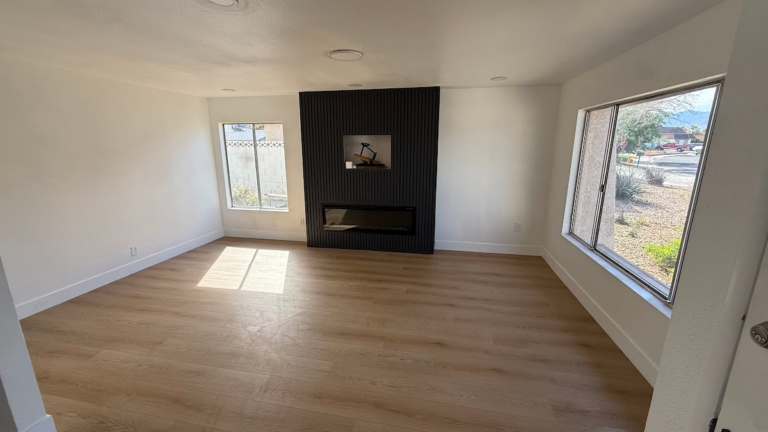 Finished living room with fireplace and windows during the Las Vegas home restoration project.