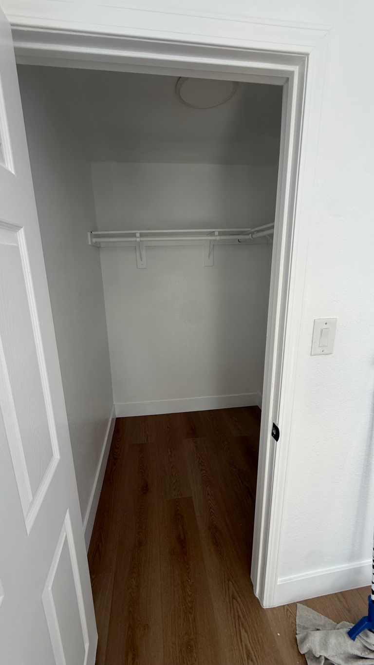 Finished walk-in closet with hanging rail during the Las Vegas home restoration project.