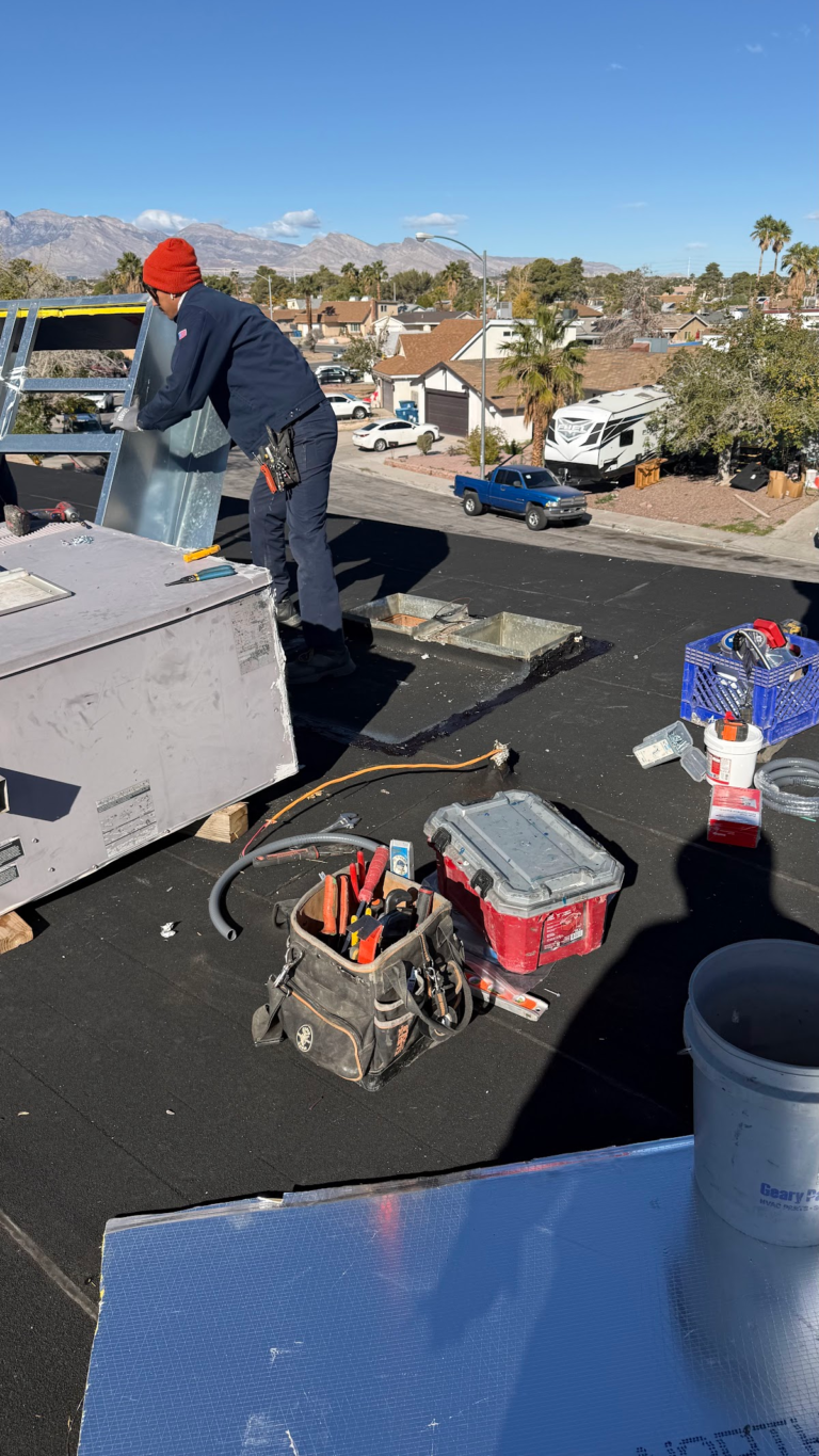 Flat roof installation beside HVAC equipment during the Las Vegas home restoration project.
