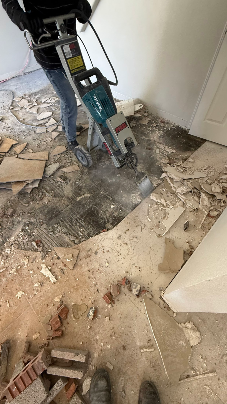 Floor demolition with power tool during the Las Vegas home restoration project.