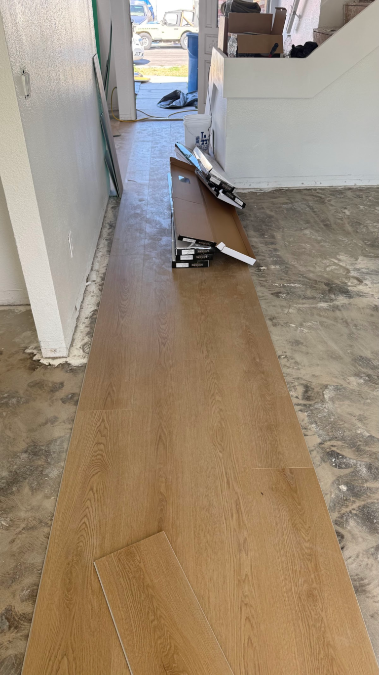 Flooring installation along hallway during the Las Vegas home restoration project.