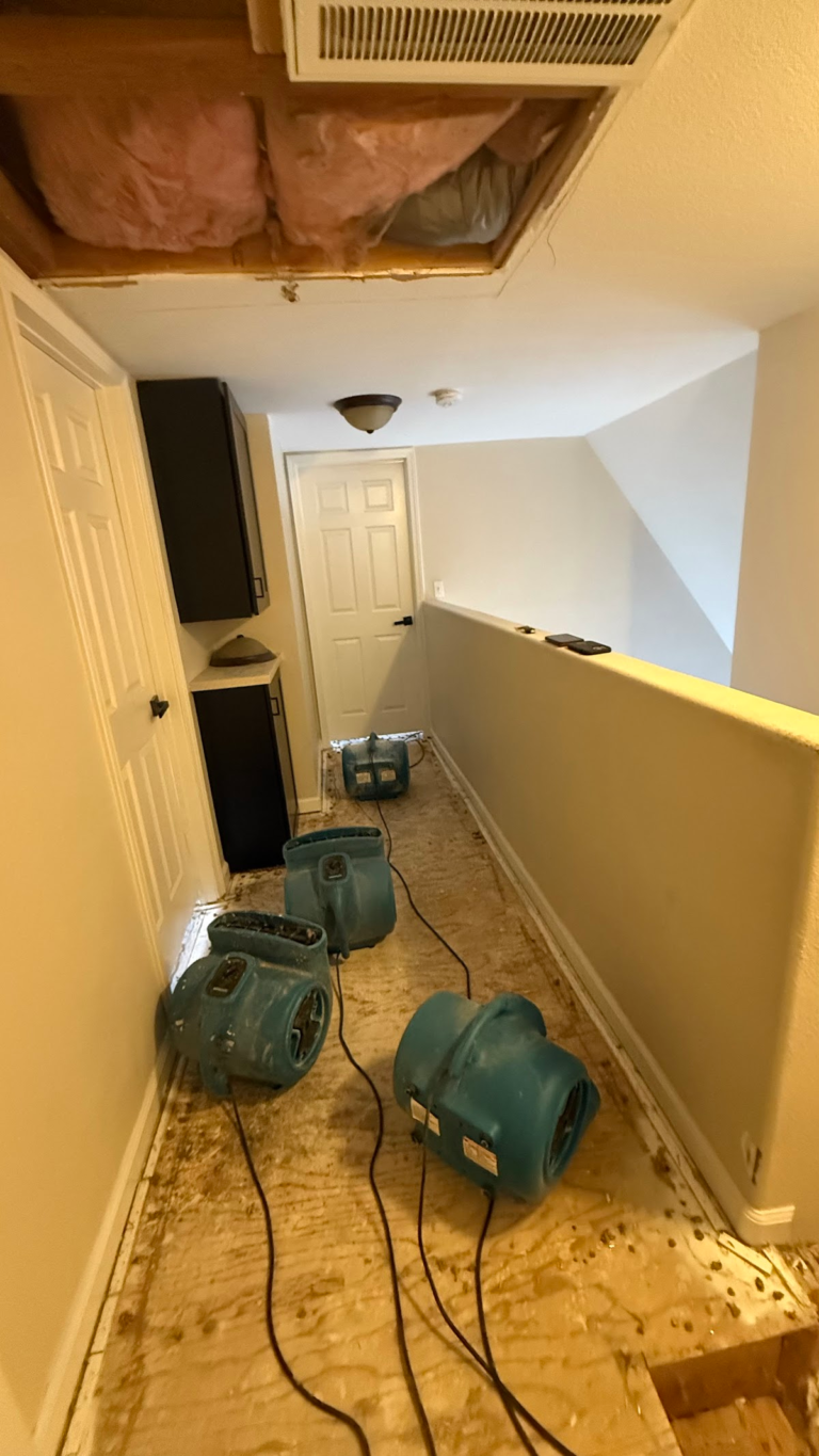 Hallway drying with exposed ceiling insulation during the Las Vegas home restoration project.