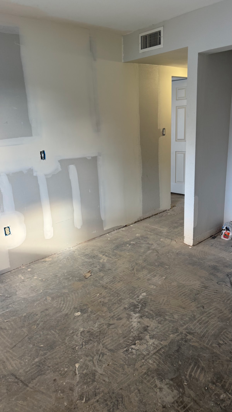Interior drywall patches before painting during the Las Vegas home restoration project.