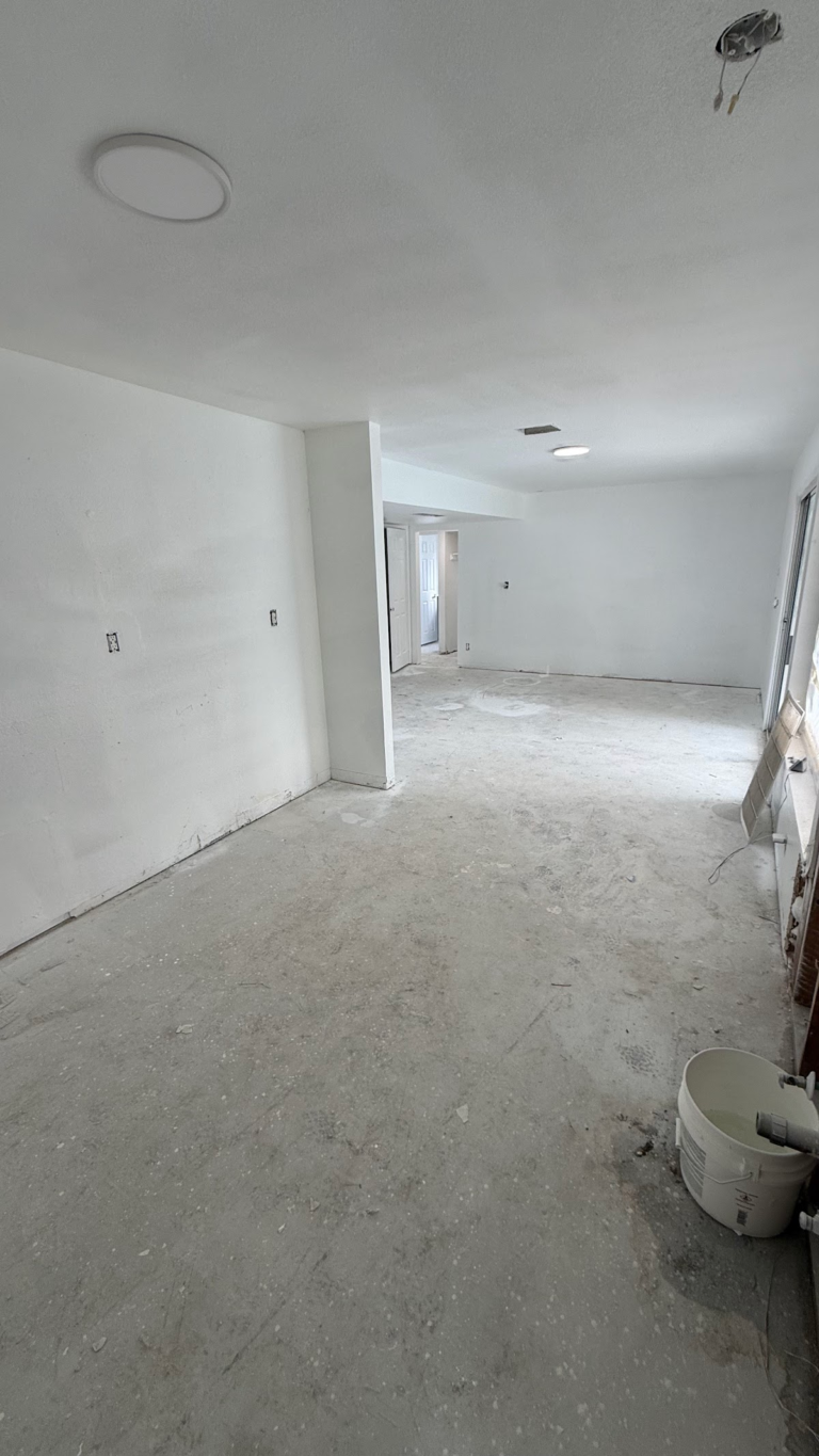 Interior hallway with painted walls and bare floor during the Las Vegas home restoration project.