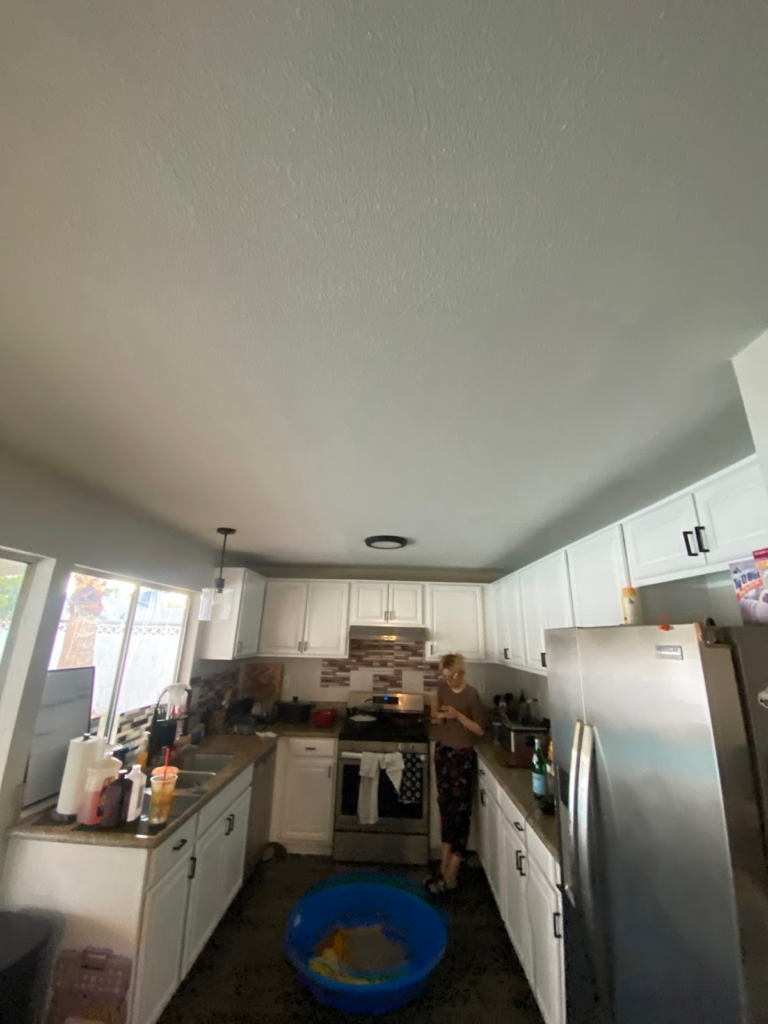 Kitchen ceiling and cabinets before restoration during the Las Vegas home restoration project.