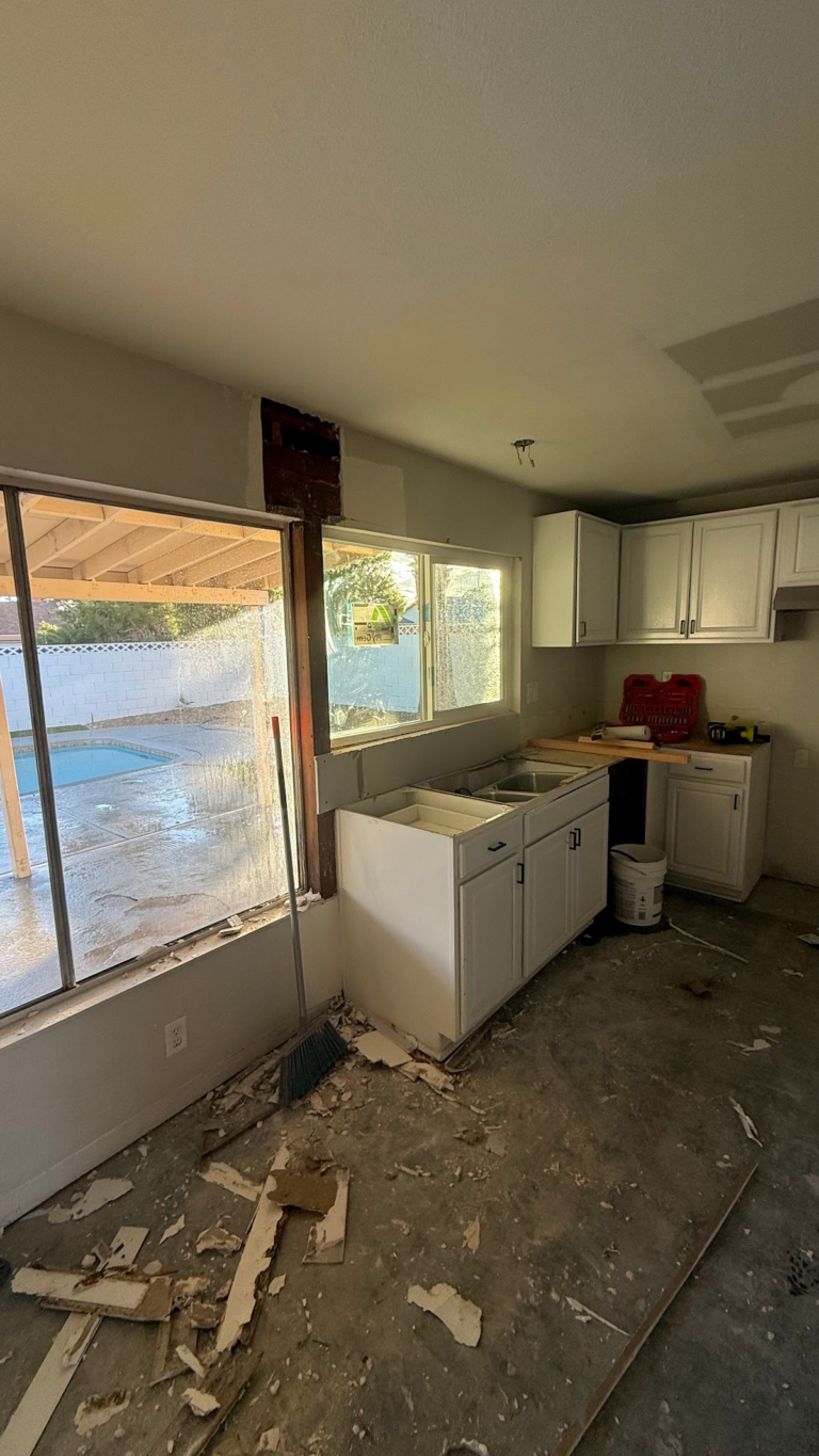 Kitchen demolition with exposed floor during the Las Vegas home restoration project.