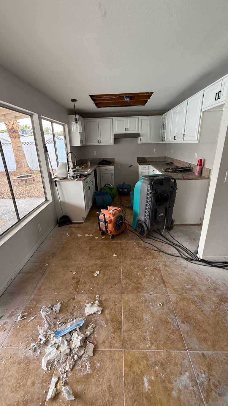 Kitchen drying equipment and damaged flooring during the Las Vegas home restoration project.
