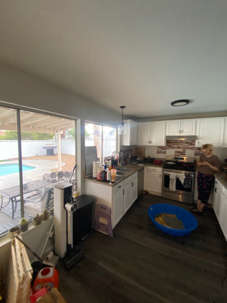 Kitchen floor and sliding door before restoration during the Las Vegas home restoration project.