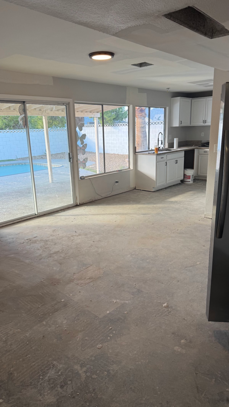 Kitchen floor preparation and ceiling repair during the Las Vegas home restoration project.