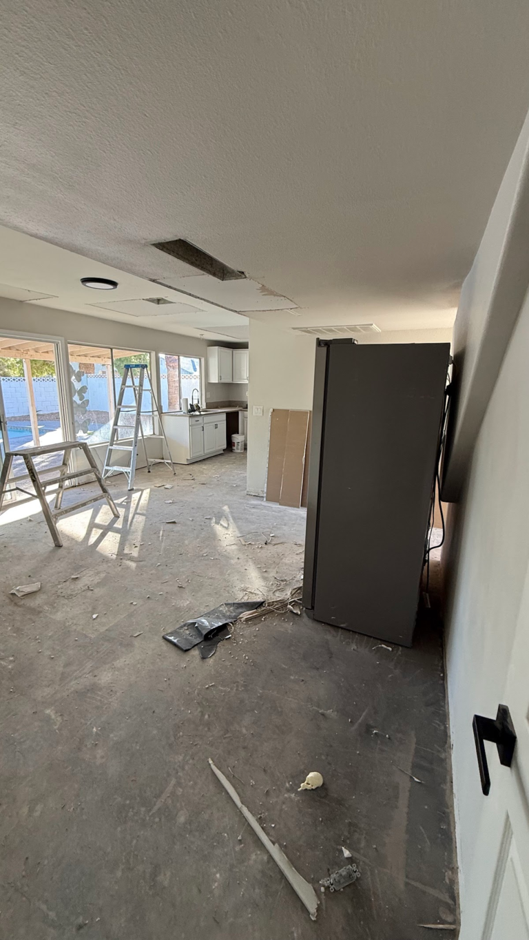 Living area ceiling patching and floor preparation during the Las Vegas home restoration project.