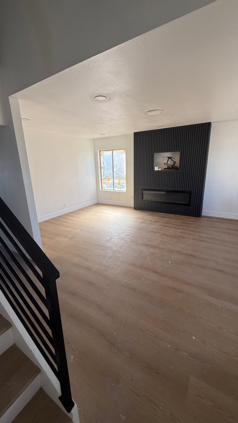 Living room fireplace and finished floor during the Las Vegas home restoration project.