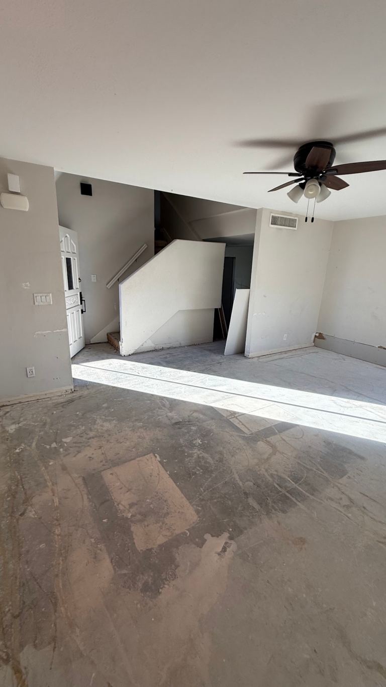 Living room floor preparation and stored doors during the Las Vegas home restoration project.
